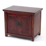Property of a lady - a Chinese red stained softwood panelled two-door side cabinet, late 19th /