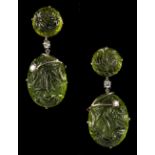 A pair of 18ct white gold carved peridot & diamond drop earrings, each with two oval peridot