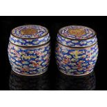 A pair of 19th century Chinese Canton enamel barrel shaped boxes & covers, each 3.15ins. (8cms.)