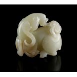 A 19th century Chinese carved pale celadon jade model of a recumbent deer with lingzhi in its mouth,