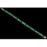 A fine 18ct white gold emerald & diamond bracelet, set with ten graduated rectangular cut emeralds