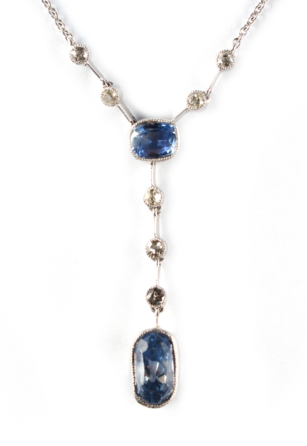 An unmarked white gold sapphire & diamond pendant necklace, the two pale blue sapphires weighing