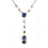 An unmarked white gold sapphire & diamond pendant necklace, the two pale blue sapphires weighing