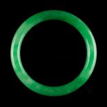 A Chinese jadeite bangle, of vivid apple green colour (see illustration).