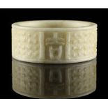 Property of a gentleman - a Chinese archaistic carved pale celadon hardstone bangle, 3.25ins. (8.