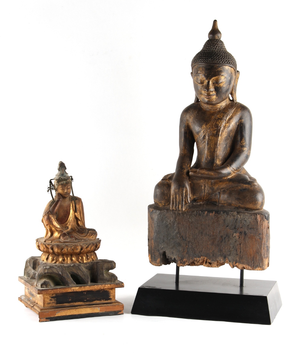 Property of a lady - a carved wood figure of a seated Buddha, mounted on a modern black stand, 19.