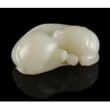 A Chinese carved white jade model of a recumbent lion cub, 1.95ins. (4.9cms.) long (see