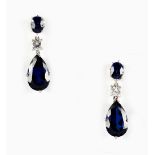 A pair of blue 'stone' & diamond pendant earrings, each with a pear shaped & an oval shaped blue '