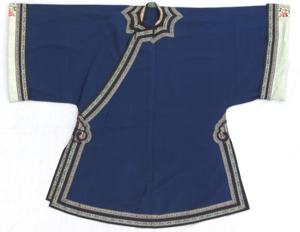 A Chinese blue silk lady's summer robe, with embroidered floral borders (see illustration).