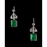 A pair of 18ct white gold emerald & diamond earrings, each with a rectangular cut emerald