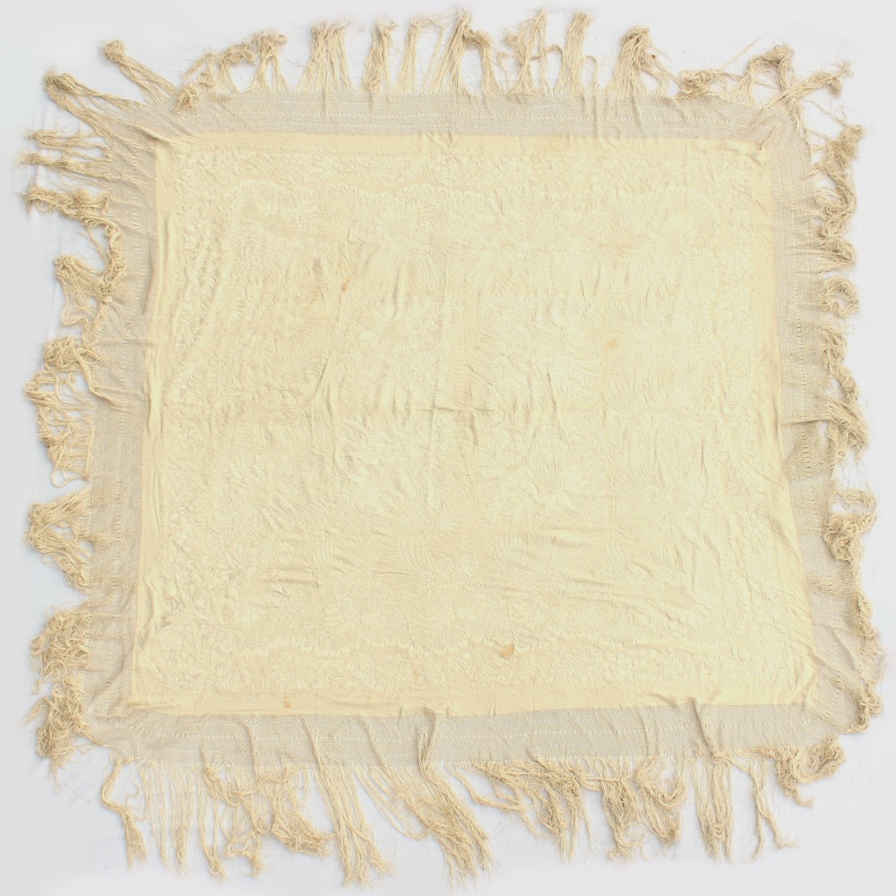 A Chinese embroidered cream silk shawl, second quarter 19th century, in original gilt decorated