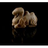 A Chinese carved brown stone model of a recumbent camel, 2.3ins. (5.8cms.) long (see illustration).