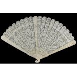 A Chinese Canton carved ivory fan, 19th century, 7.5ins. (19.1cms.) long (see illustration).