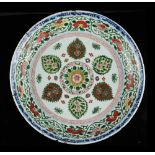 A Chinese famille verte shallow dish, Kangxi period (1662-1722), with a ring of six palmettes within