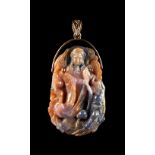 A large natural sapphire pendant, carved with a figure of Guanyin, on unmarked yellow gold