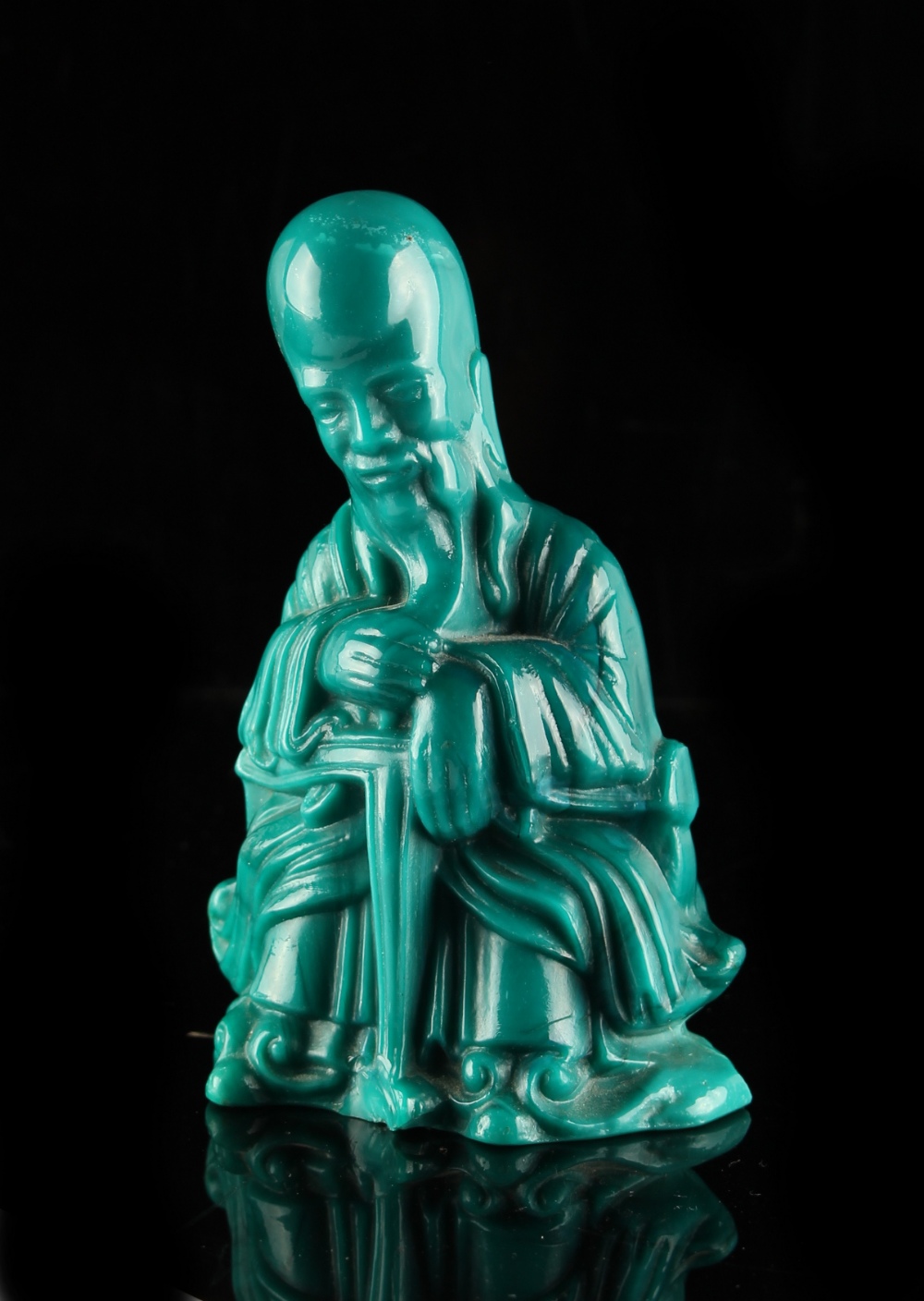 A Chinese blue Peking glass figure of a bearded scholar, early 20th century, 4.5ins. (11.4cms.) high