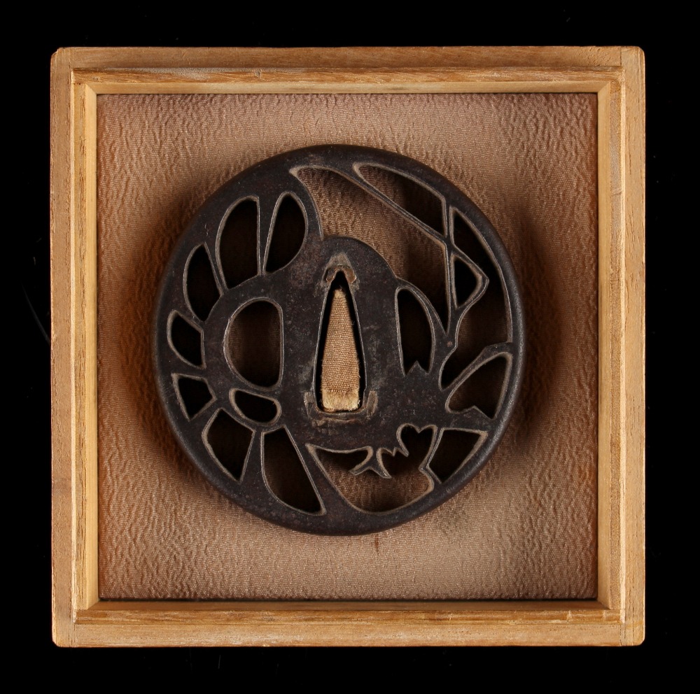 Property of a gentleman - a Japanese Akasaka iron tsuba, Edo period (1615-1868), with openwork