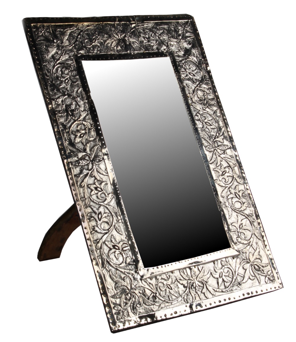 An early 20th century white metal rectangular framed easel mirror, probably Colonial Indian,