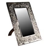 An early 20th century white metal rectangular framed easel mirror, probably Colonial Indian,