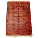 Property of a lady - an early / mid 20th century Turkoman rug, with two columns of guls, 63 by