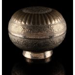Property of a lady - an Indian white metal bun shaped box, 8.85ins. (22.5cms.) diameter,