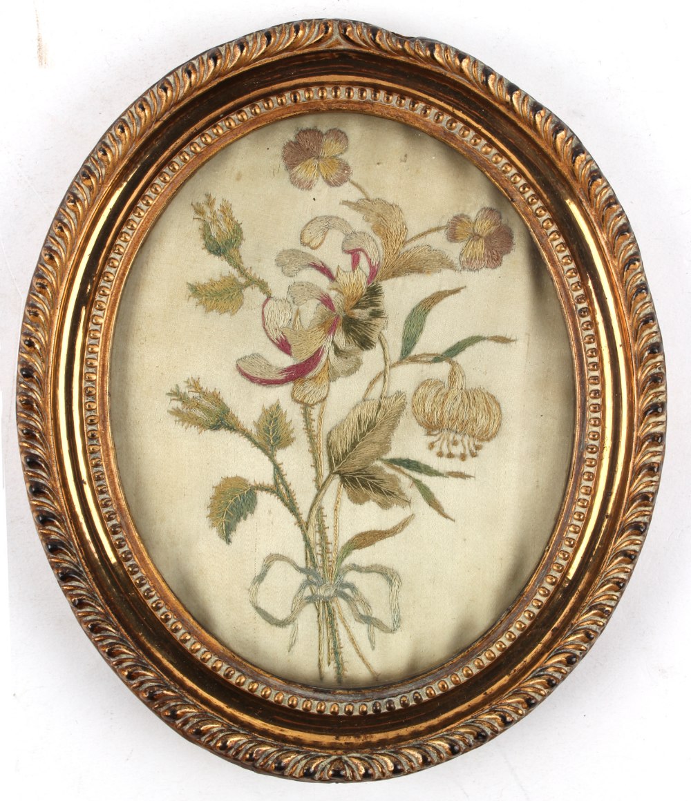 Property of a lady - a small George III gilt oval framed silkwork picture of flowers, with old