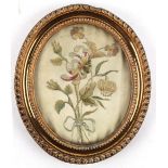 Property of a lady - a small George III gilt oval framed silkwork picture of flowers, with old