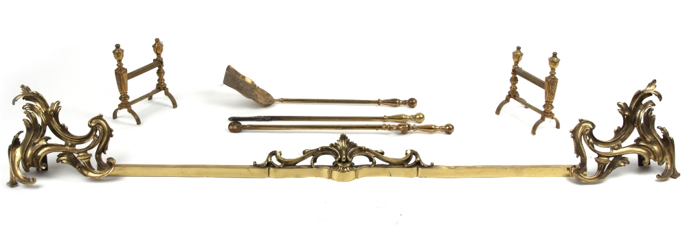 Property of a lady - a French Louis XV style gilt brass rocaille adjustable fender, the bar