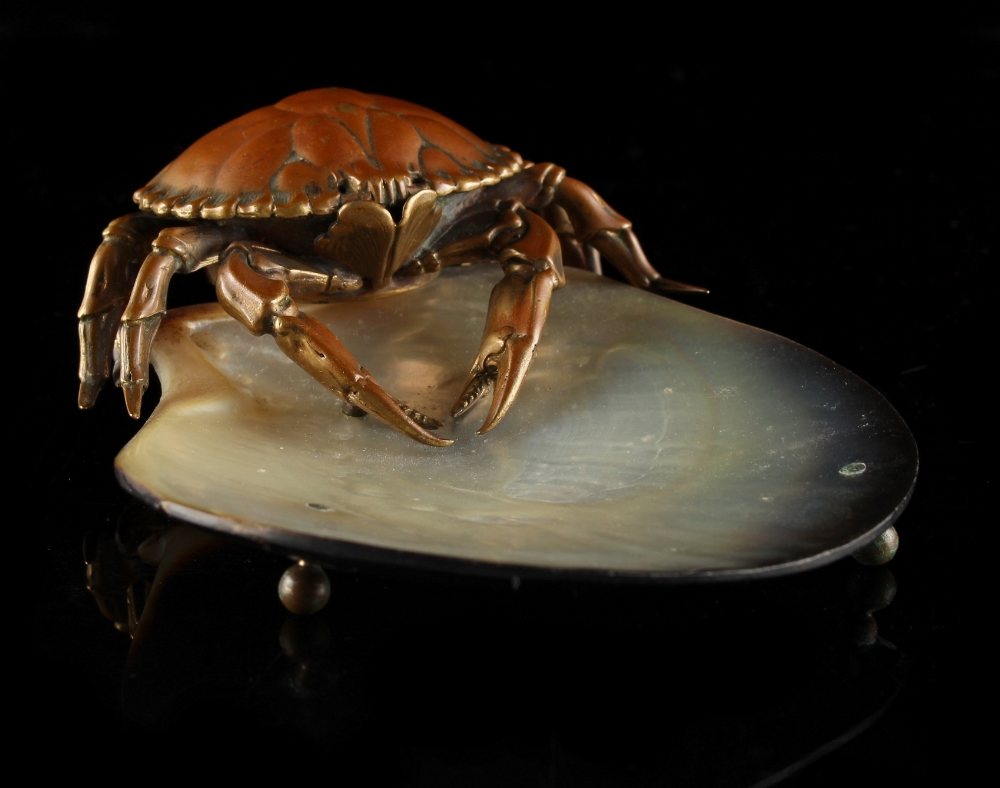 An abalone shell dish mounted with a bronze model of a crab, probably Japanese, 5.5ins. (14cms.)