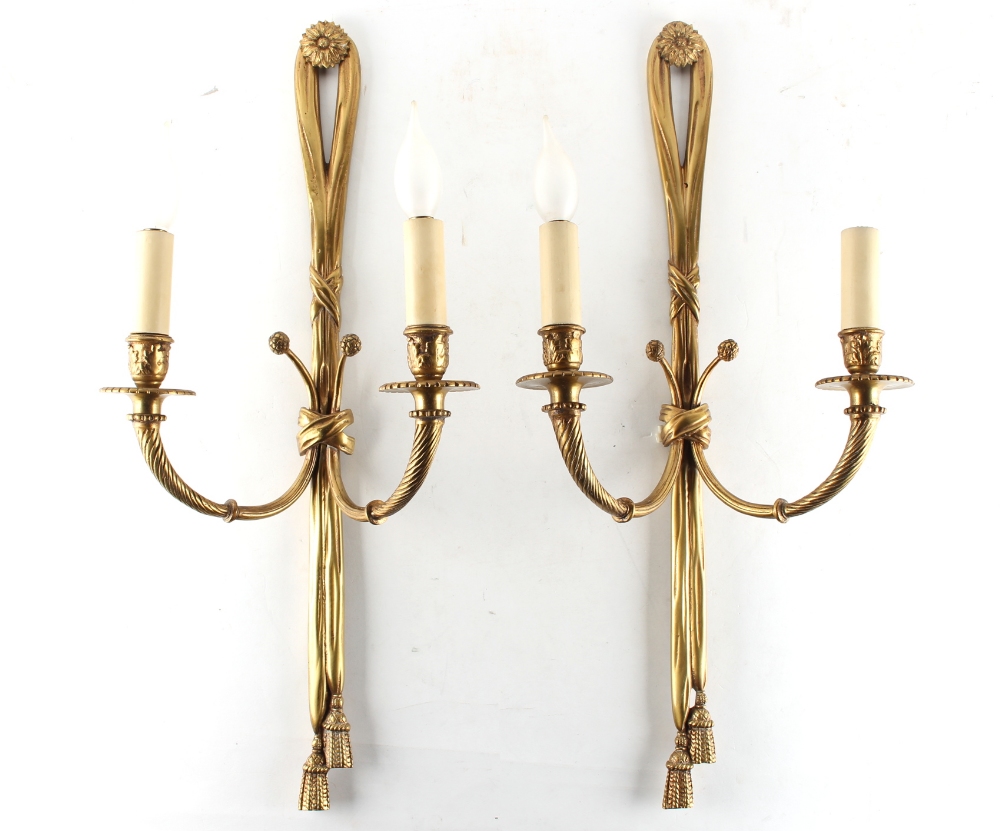 Property of a lady - a pair of gilt brass or ormolu tasselled ribbon twin light wall appliques, each