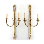 Property of a lady - a pair of gilt brass or ormolu tasselled ribbon twin light wall appliques, each