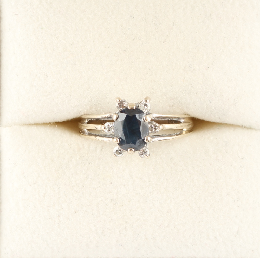 Property of a lady - an 18ct white gold oval cut sapphire & diamond ring, with pierced shoulders,