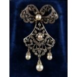 A late 19th century pearl & paste ribbon & foliate pendant brooch, indistinctly marked to