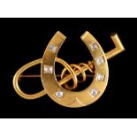 A unmarked yellow gold (tests high carat) brooch modelled as a horseshoe & riding crop, the