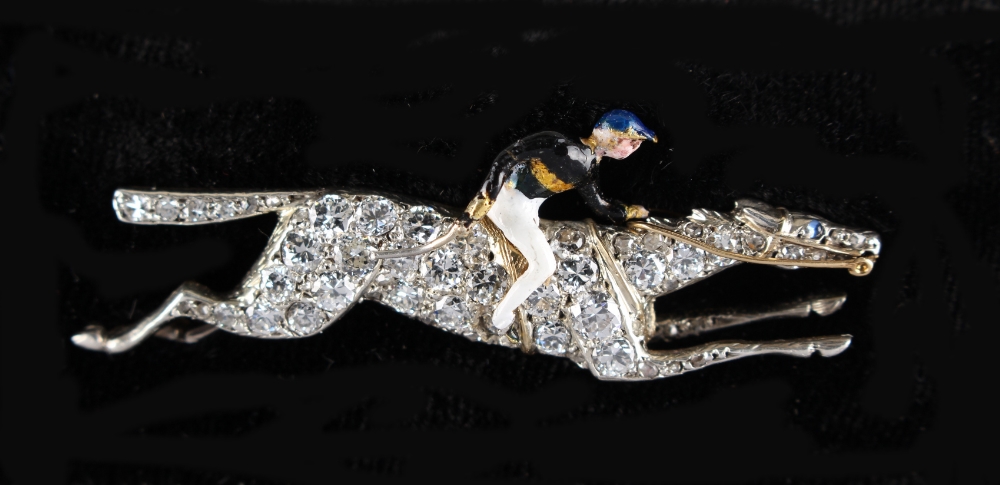 A diamond & enamel horse & jockey brooch, the estimated total diamond weight 1.65 carats, 1.