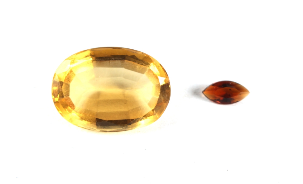 Property of a gentleman - a large loose oval cut citrine, approximately 24mm long; together with a