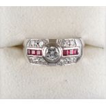 Property of a lady - an 18ct white gold ruby & diamond ring, with central collet set diamond