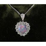 An 18ct white gold black opal & diamond heart shaped pendant on chain, the black opal