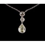 A platinum diamond three-stone pendant necklace, the largest pear shaped diamond weighing