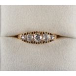 A late Victorian unmarked yellow gold graduated five stone diamond ring, the largest of the Old