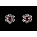 A pair of 18ct white gold ruby & diamond cluster earrings, the estimated total diamond weight 1.20