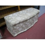 Rectangular Shaped Ottoman, with a hinged lid, upholstered in a light brown floral upholstery.