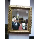 Late XIX Century Rectangular Bevelled Wall Mirror, in gilded frames decorated with flowerheads,
