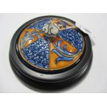 A Moorcroft Pottery Paperweight, decorated with the Aurelian Dream design, 10.5cms diameter, on a