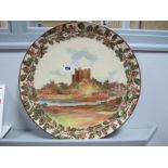 A Royal Doulton Circular Charger, decorated with a castle scene surrounded by a band of oak