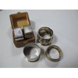 A Pair of Hallmarked Silver Napkin Rings, engine turned in fitted case; together with three