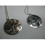 Norman Grant; Two Hallmarked Silver and Enamel Disc Pendants, each on a chain. (2)