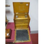 An Edwardian Oak Stationery Cabinet, the fall front revealing leather scriver, two drawers, statione