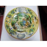 Continental Pottery Charger, circa early XX Century featuring arable scene within a cherub and