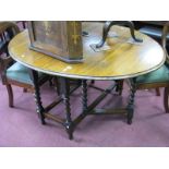 1920's Oak Gate Leg Table, with an oval top, on barley twist and block supports.